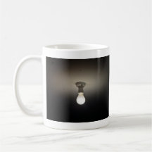 Frosted light-bulb in dark room mugs