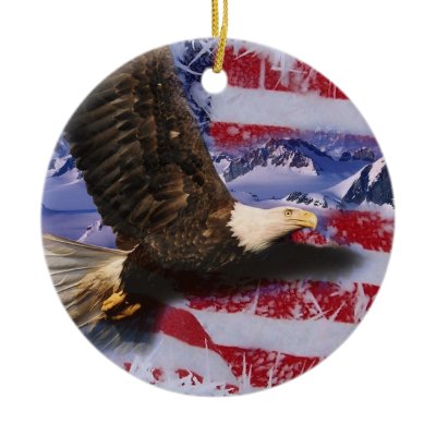 american flag waving eagle. A beautifully patriotic image of an American Bald Eagle bird soaring over snow covered mountains, on a waving American Flag bordered with frozen snow and