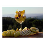 Fruit cocktail and fruits around it postcard