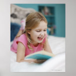 Girl laying in bed reading book posters
