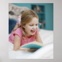 Girl laying in bed reading book posters