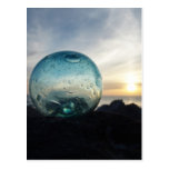 Glass float and sunset postcards