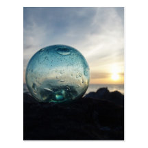Glass float and sunset postcards
