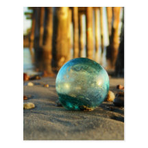Glass float in front of pier post cards