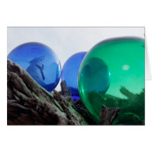 Glass floats on gray driftwood greeting card
