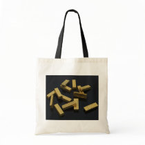 Gold bars in bulk on a black background bag