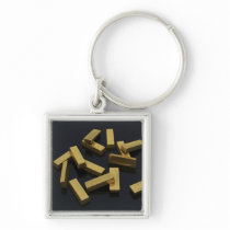 Gold bars in bulk on a black background keychain