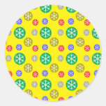 Gold silver red green snowflakes on yellow sticker