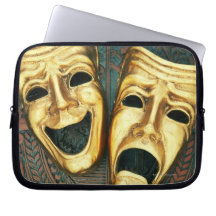 Golden comedy and tragedy masks on patterned computer sleeves