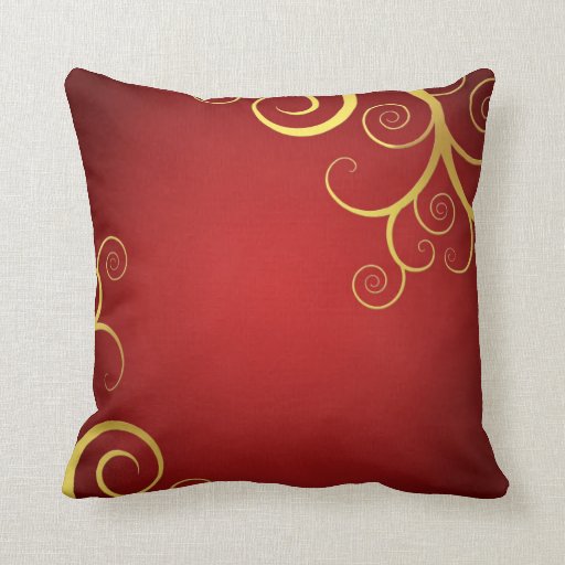 Golden swirls on deep red pillow Zazzle