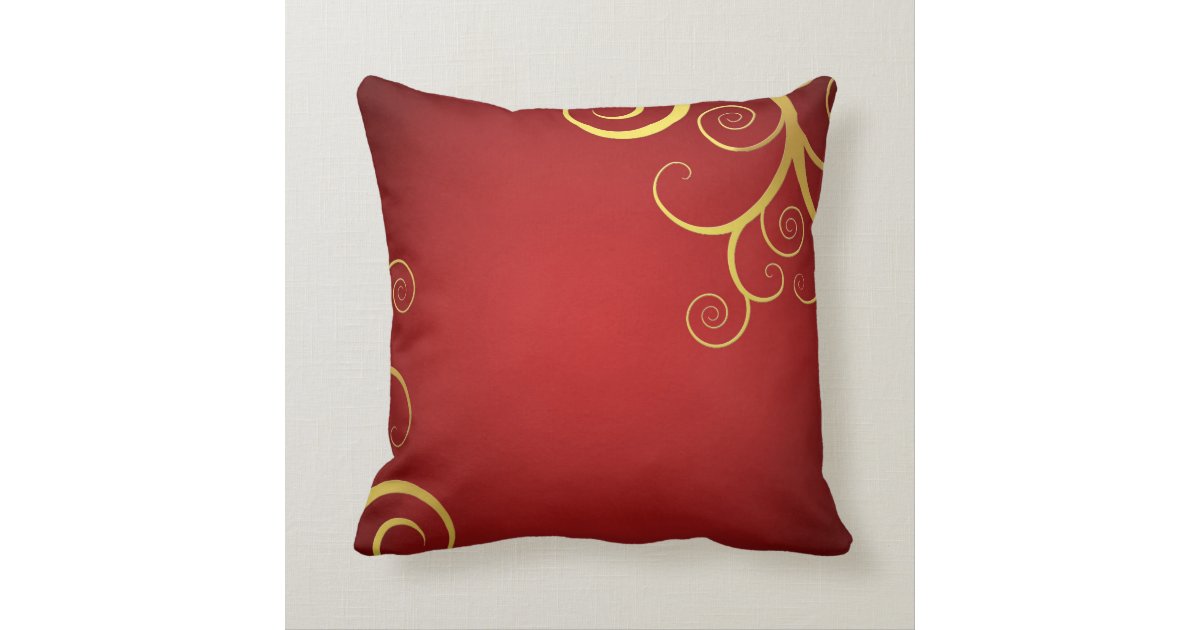 Golden swirls on deep red pillow Zazzle