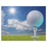 golf ball on a tee with grass flyers