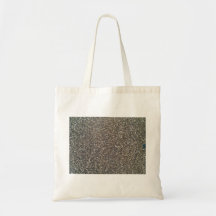 Gravel, pebbles and sand close up tote bags