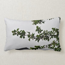 Green leafy branch against the cloudy sky pillow