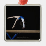 Gymnast (9-10) flipping on balance beam, side christmas ornament