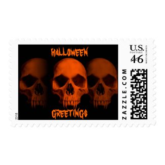 Halloween horror fanged skulls in black and orange postage stamp