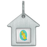 Hand holding abstract yellow baby bottle pet ID tag