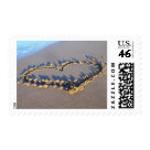 postcard - Love stamps, with a heart drawn in the sand.  Customize with your own text if you wish..