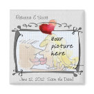 square_magnet - Here is a do it yourself save the date wedding photo magnet template.  It has an artsy frame and heart and is layered upon an off white textured fabric background (canvas looking) with a calligraphy font and a decorative accent squiggle line. Simply replace your names, the dates, and upload your own photo to go into the frame by hitting "change" under the cartoon couple photo icon.   To choose a new background color or upload your own textured, or colored background simply click "change" below the fabric picture icon.  If you clear it, the background will be a medium dark gray.  If you hit the "customize it" button you may choose any background color and edit the font style and color, and rearrange the design, resize, and add more text.  and Congratulations on your engagement and wedding to be!