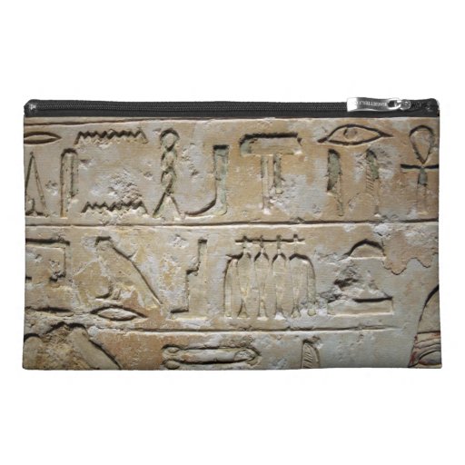 Hieroglyphics on a stone wall travel accessory bags