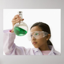 Hispanic girl looking at liquid in beaker posters