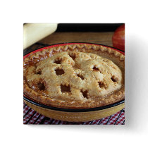 Home baked apple pie on cooling rack with apple button