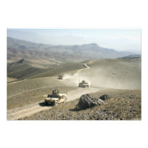 Humvees traverse rugged mountain roads
