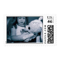 I hold my stuffed bunny postage