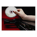 Inserting CD into CD player cards