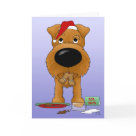 postcard - Irish Terrier trying to get away with eating all of Santa's cookies. Irish Terrier is wearing a Santa Hat, with ginger bread man in his mouth and inside of card reads, "Ho...  Ho...  Ho???"