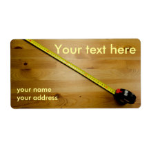 Label with tape measure on wooden background