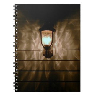 lamp with angel wings reflection on wall note books