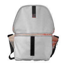 Light pink rose reflection in silver courier bag