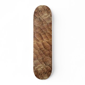 Lines carved in pale brown wood skateboard