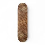 Lines carved in pale brown wood skate board deck