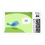 Little blue bird with speech bubble on green postage stamps
