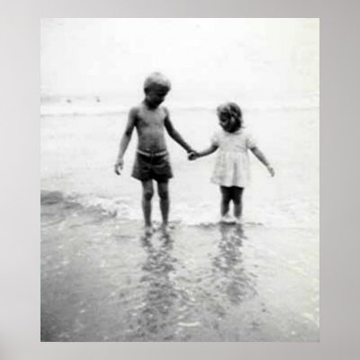 boy and girl holding hands on the beach