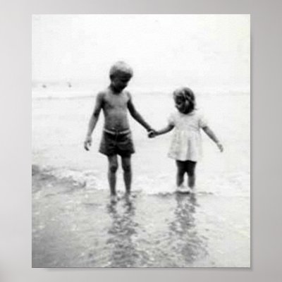 boy and girl holding hands on the beach