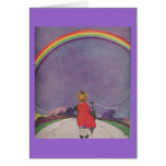 Little girl looking at rainbow card