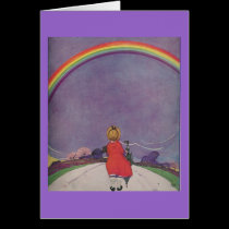 Little girl looking at rainbow card cards