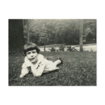 Little girl lying on the grass postcards