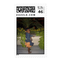 Little girl posing with flowers postage