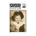 little girl with her doll on stamp