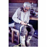 Local resident working on dog sled harness photo cut out