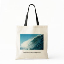 Looking into the eye of a breaking wave canvas bags