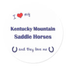 round_sticker - Show the world how much you love your Kentucky Mountain Saddle Horses (and that the feeling is mutual!). With a heart and two horseshoes, the words read 'I love my Kentucky Mountain Saddle Horses and they love me'. This design is specifically for multiple horses (they), we also have variants available for a male horse (he) or female horse (she). A perfect gift for yourself or the Kentucky Mountain Saddle Horse lover in your life, this design is available on a variety of gift and apparel items!