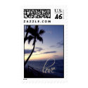 Love on sunset beach postage