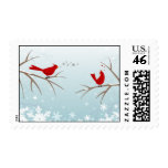 Lovebirds on snowy branches postage