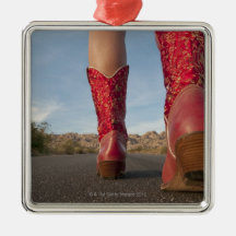 Low-angle view of woman wearing cowboy boots ornament