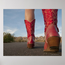 Low-angle view of woman wearing cowboy boots poster